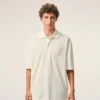 Hvit bomullspolo med strikket Ami de Coeur Polo-merke